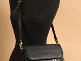 a black leather bag on a mannequin mannequin mannequin mannequin mannequin mannequin mannequin mannequin manne
