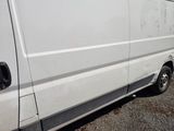 a white van that is parked on the side of the road