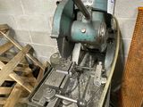 a machine that is sitting in a room next to a pile of wood