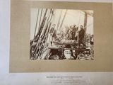 a black and white photo of a group of men on a boat