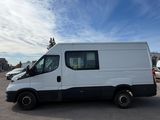 a white van parked in a parking lot with other cars