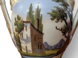 a vase with a picture of a house on it