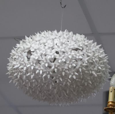 une lampe blanche suspendue au plafond dans une pièce
