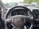 the interior of a car with a steering wheel and dashboard controls