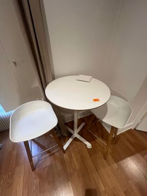 a small table and two chairs in the corner of a room