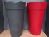 two cups that are sitting on a shelf next to each other