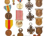 an assortment of medals and medals are displayed on a white surface