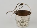 a silver cup with a handle and a handle on the handle