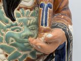 a figurine of a man with a long black hair