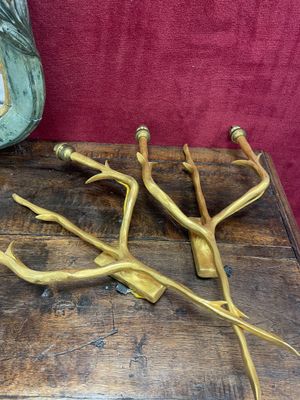 a wooden table topped with a bunch of brass utensils