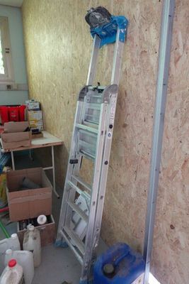 une échelle appuyée contre un mur dans une pièce