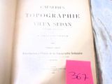 a book with a pink sticker on it sitting on a bed