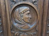 a wooden carving of a woman with a headscarf