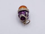purple and orange glass bead with silver wire wrapped around it