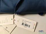 two luggage tags attached to a bag on a table