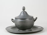 silver plate with saucer and saucer on it on a white surface