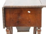 a small wooden table with a drawer underneath it