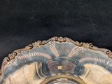 a silver plate with a clock on it on a table