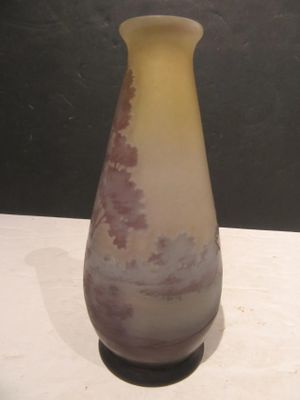 a vase that is sitting on a table with a black background