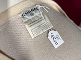 a label that says chanel on the back of a dress