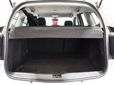 the back of a car with its trunk open and the back seats folded down