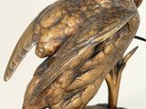 a statue of a bird that is sitting on top of a table