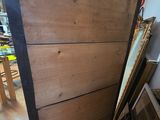 a wooden door with a mirror on it in a room