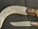 two knives that are laying next to each other on a table