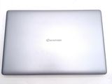 a silver laptop sitting on a white surface