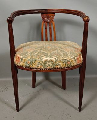 a wooden chair with a floral upholstered seat