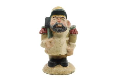 a figurine of a man with a cell phone in his hand