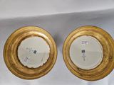 pair of gold and white plates with blue and white designs on them