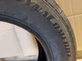 a close up of a tire on a tile floor with a wall in the background