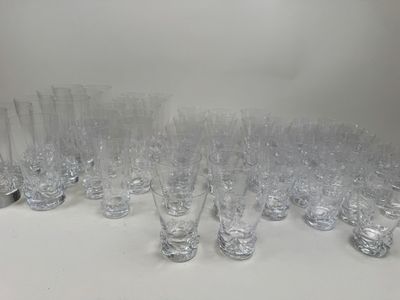 a lot of glasses that are lined up on the table