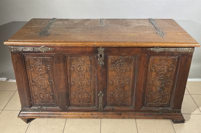 an old wooden chest with ornate carvings on the top