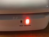 a white box with a red light on top of it