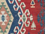 a close up of a red, blue, and green area rug