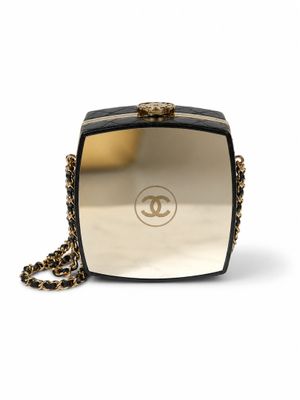 a chanel black and gold clutch bag with chain strap