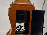 a wooden clock with a glass in the middle of it