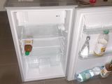 a small refrigerator with a lot of food inside of it