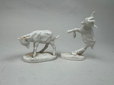 two figurines of a bull and a cow on a table