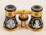 a gold and black binoculars with pictures of people on it