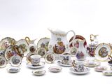 many different types of porcelain dishes and cups on the table