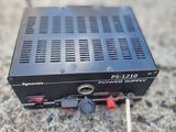 a close up of a power supply sitting on a concrete surface