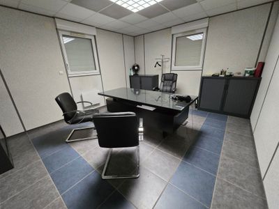 a desk with two chairs and a computer on it
