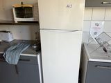 a refrigerator and a sink in a small kitchen