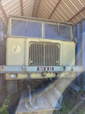 a large yellow truck that is parked in a garage