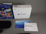a box of games and a remote on a table