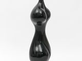 a close up of a black sculpture on a white background