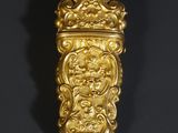 a gold plated wall hanging with a lion head on it